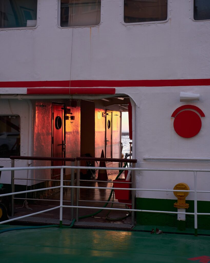 a white building with red and white doors
