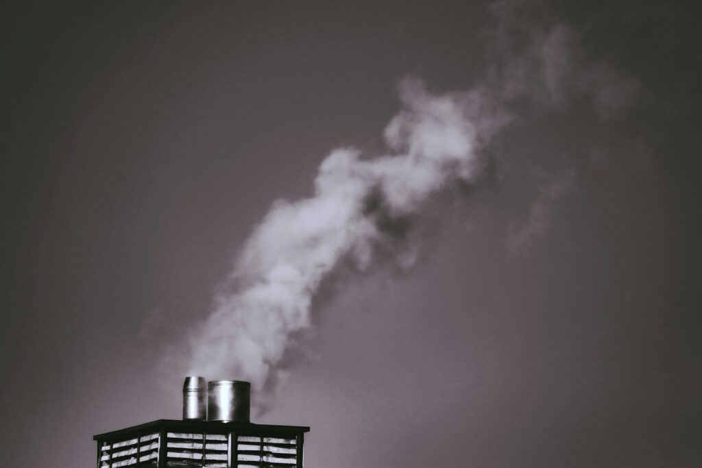 white smoke coming out from a black metal gate