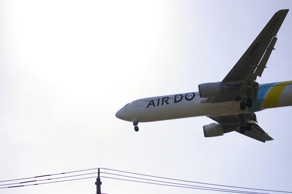 a large jetliner flying through a cloudy sky