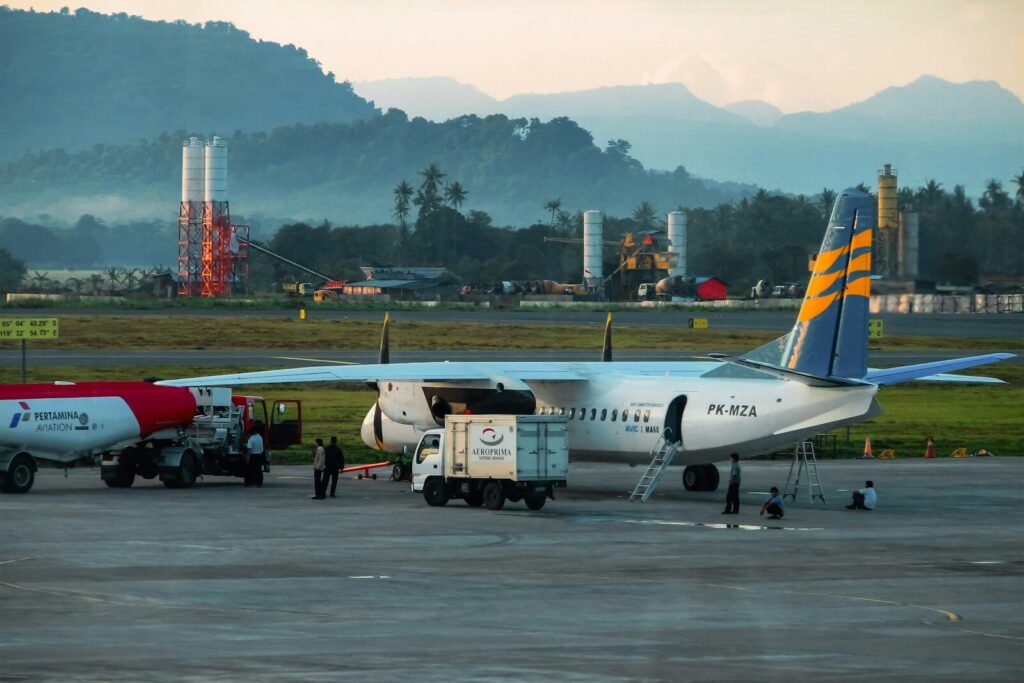 An airplane is being loaded on the tarmac.