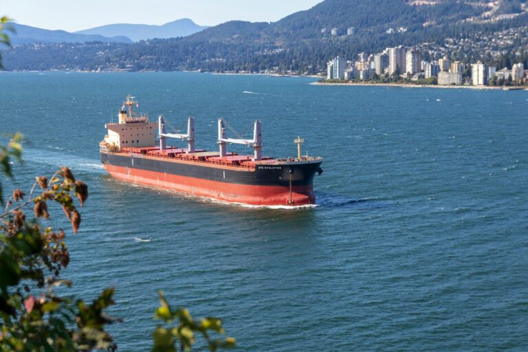 cargo ship sailing near city