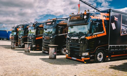 A row of semi trucks parked next to each other