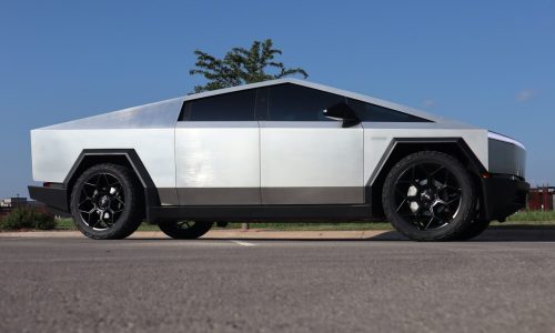 a futuristic car is parked on the side of the road