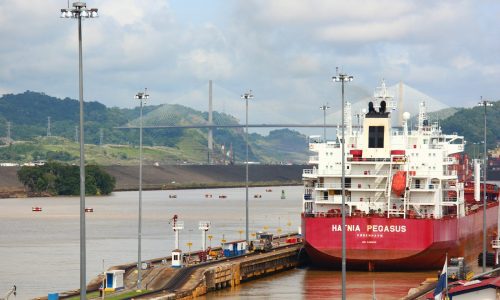 a large red and white boat docked at a dock
