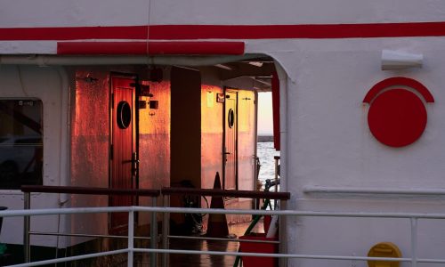 a white building with red and white doors