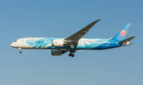 white and blue air plane in mid air during daytime