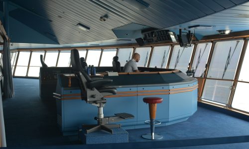 man standing inside boat