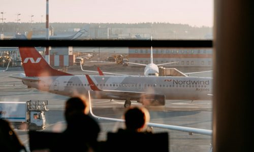 a group of people looking at an airplane at an airport
