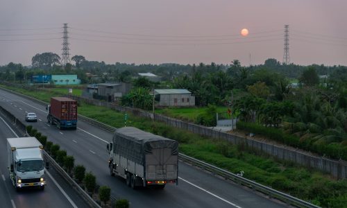a couple of trucks driving down a highway